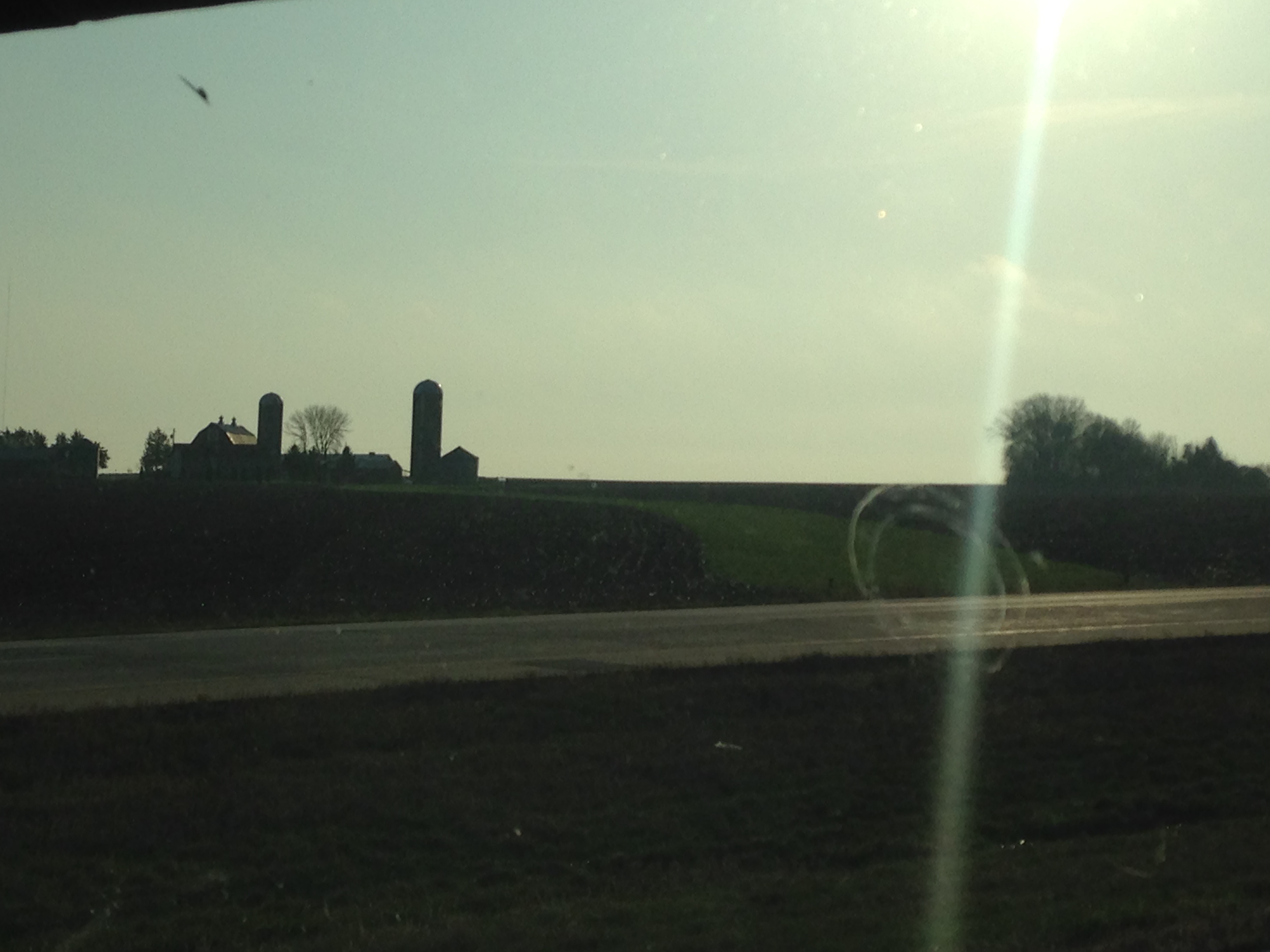 Farm silos from a car on the highway