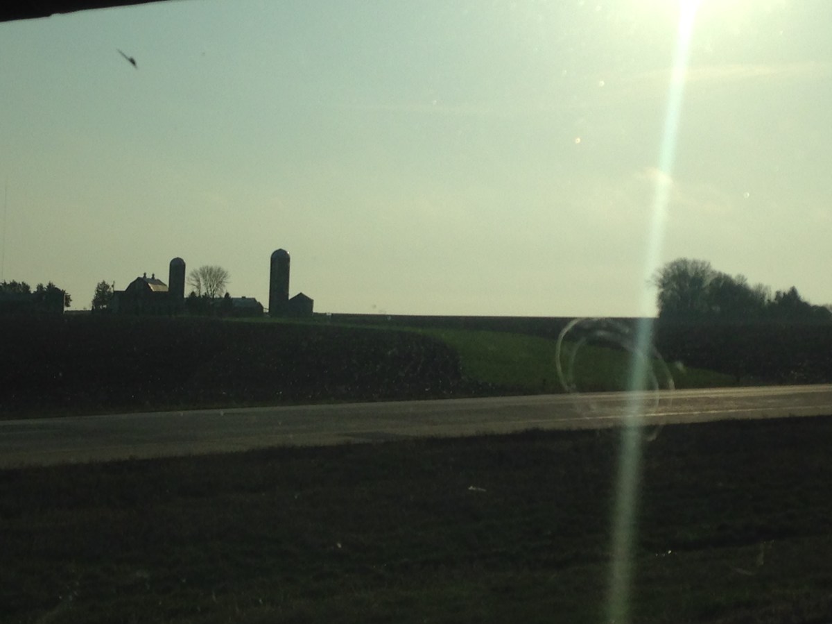Farm silos from a car on the highway