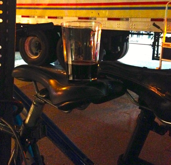 Plastic cup of wine on a bike seat