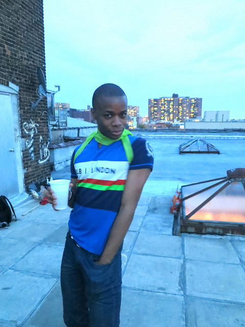 Man holding cup on roof