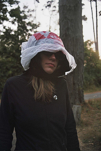 Woman outdoors with plastic bag hat