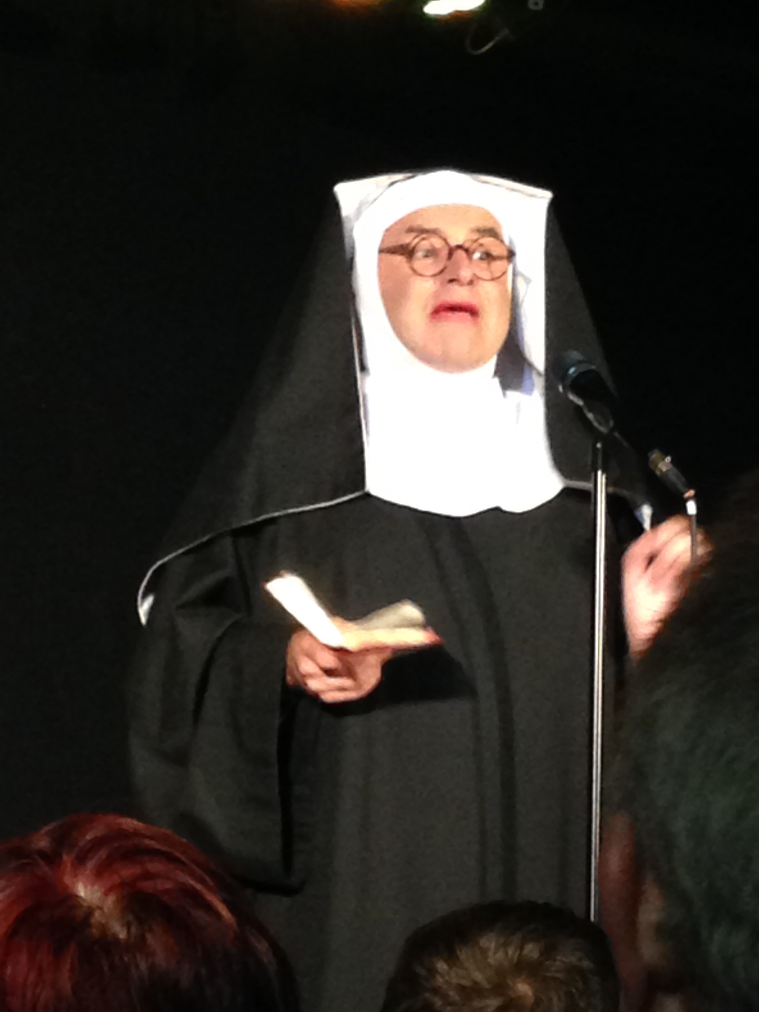 Drag nun with round glasses