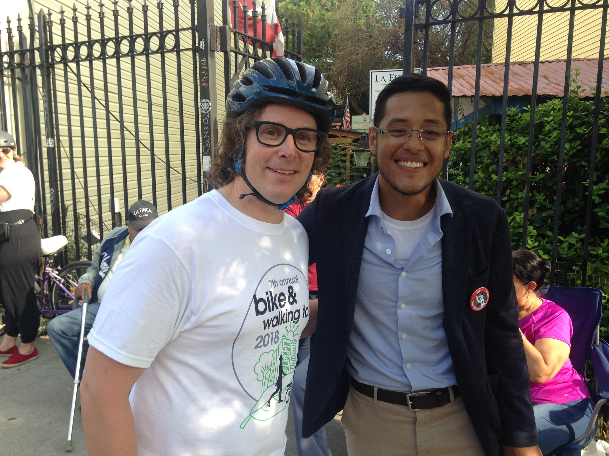 Guy in bike helmet and glasses next to guy in blazer