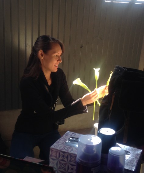 Dark haired woman with three calla lilies